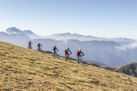 A group of women ride Class-1 electric mountain bikes in the Bavarian Alps of Germany.