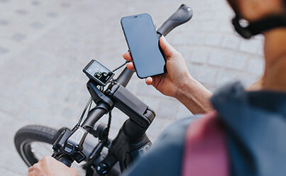 a rider on a Bosch eBike consulting their phone