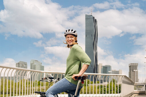 A woman rider enjoying the city view from her eBike