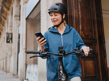 A city eBike rider stops to consult her phone