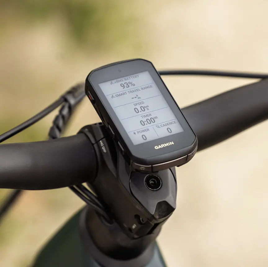 Nærbillede af en Garmin cykelcomputer monteret på frempinden af et eMountainbike-styr. Displayet viser eBike-specifikke data som et batteriniveau på 93 % og intelligent rækkevidde, mens hastigheds- og timerværdierne er nul, fordi eBike står stille.
