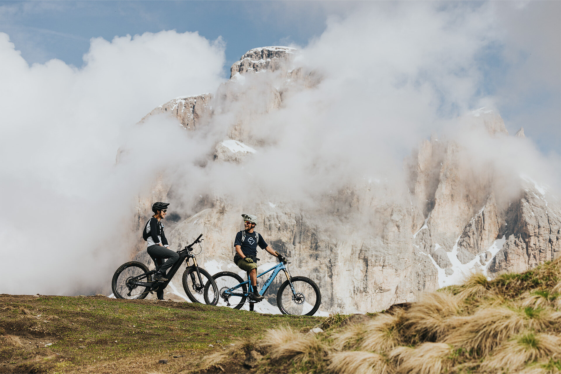 Two eBikers take a brief break on a mountain pass in South Tyrol.