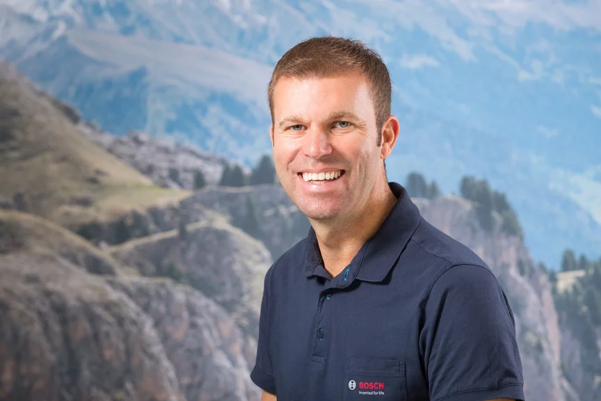 Portrait of Harald Sterzl with mountains in the background.