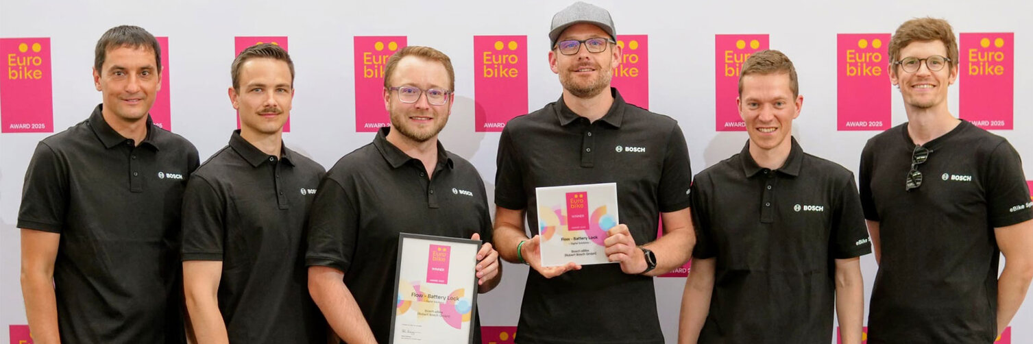 A group photo of six people receiving an award for the Bosch eBike anti-theft solution, "Battery Lock," at Eurobike 2025.