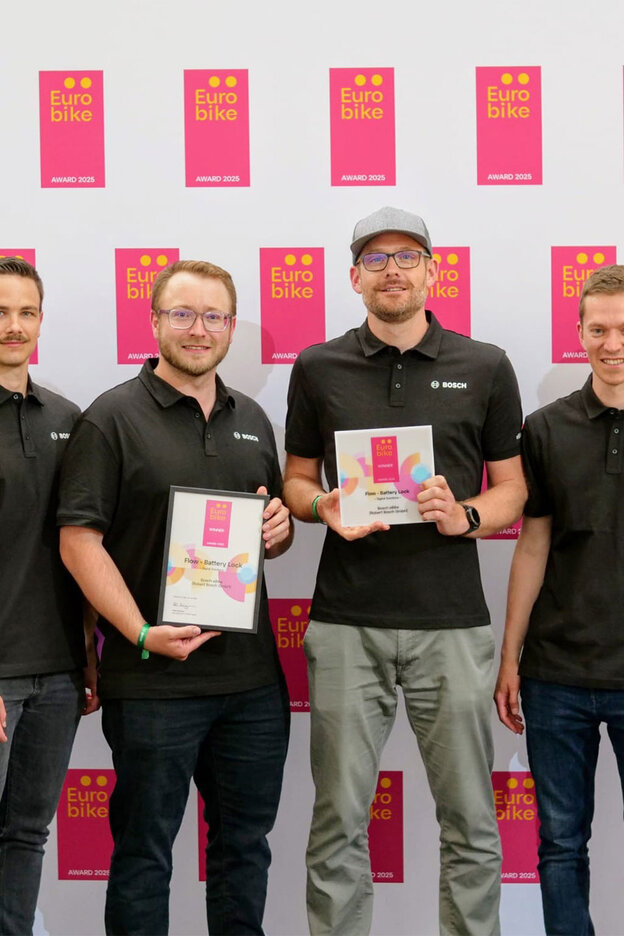 A group photo of six people receiving an award for the Bosch eBike anti-theft solution, "Battery Lock," at Eurobike 2025.