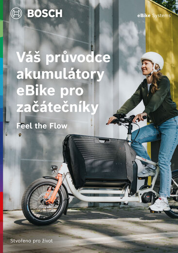 Obálka produktové brožury s textem "Průvodce pro začátečníky vašeho eBike / elektrokolo" pod textem "Feel the Flow". Na pozadí je eBikerka. Vpravo nahoře je "eBike / elektrokolo Systems".
