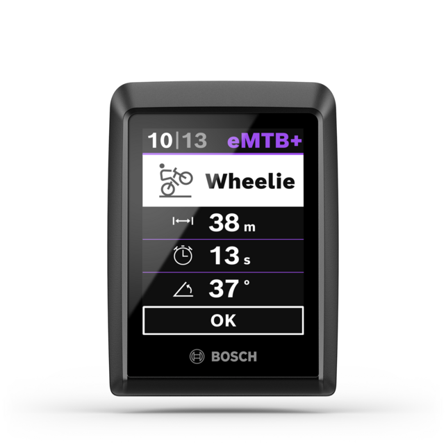 Close-up of the Bosch eBike display Kiox 300. The display shows the trick statistics for a wheelie, including distance, duration, and angle. eMTB+ is selected as the riding mode.