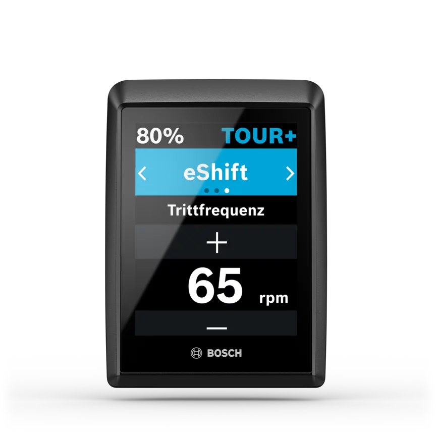 Screenshot van een eBike-display met de huidige trapfrequentie van 65 rpm in de eShift-modus en de TOUR+-rijmodus.
