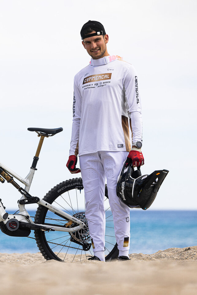 Mathieu Ruffray from the Commencal Enduro Project Racing Team stands next to his eBike.