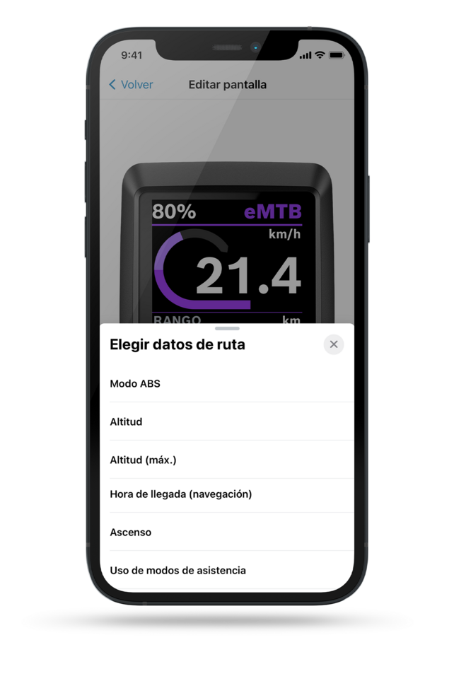Captura de pantalla de un display de teléfono muestra un display Kiox en segundo plano, con un menú con el texto 'seleccionar datos de conducción' abierto. Entre las opciones se encuentran: modo ABS, batería (eBike), batería (teléfono), hora de llegada (navegación), ascenso, duración del frenado.