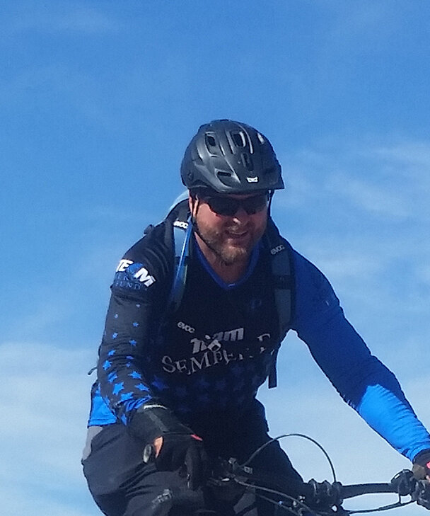 An eBike rider against a blue sky.