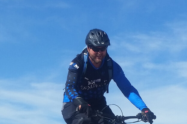 An eBike rider against a blue sky.