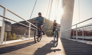 Two eBike riders going over a bridge in Los Angeles