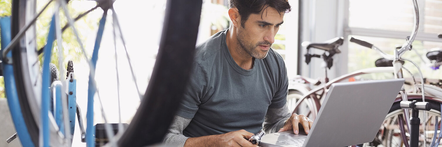 A service employee sits at his laptop