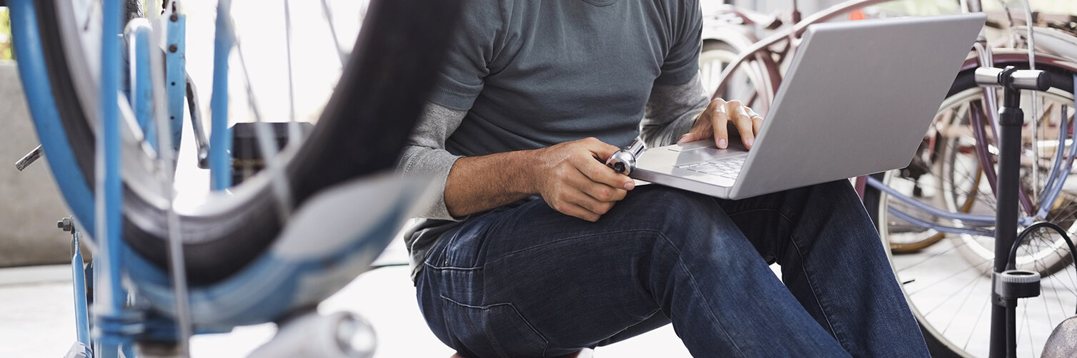 A service employee sits at his laptop