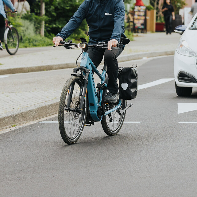 A man stops at a busy intersection.