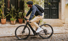 The eBiker rides along a cobblestone path in the city.
