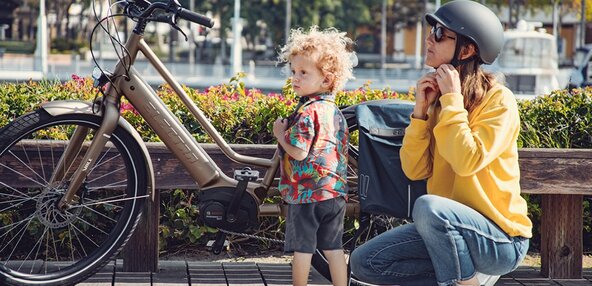 A mother with a child and an eBike 