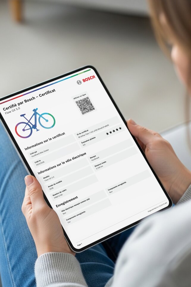personne tenant une tablette affichant un certificat numérique « Certifié par Bosch » pour un VAE Bosch.