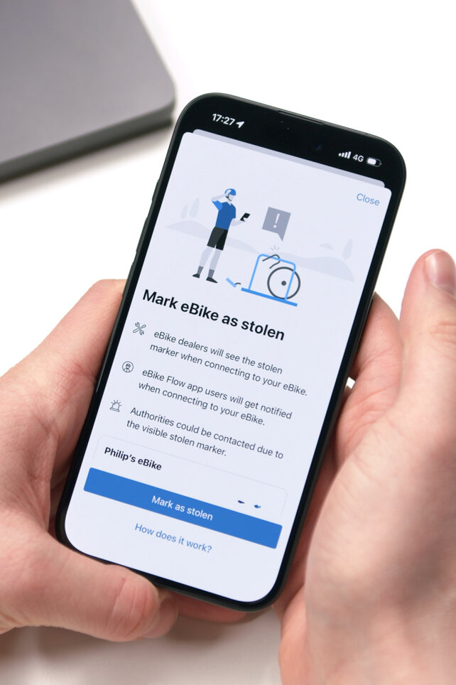 Detailní záběr na smartphone, který zobrazuje funkci 'Označit eBike / elektrokolo jako ukradené' v Bosch aplikace eBike Flow. Zobrazení vysvětluje, jak označení informuje specializovaný prodejce a další uživatele aplikace o krádeži při pokusu o připojení.