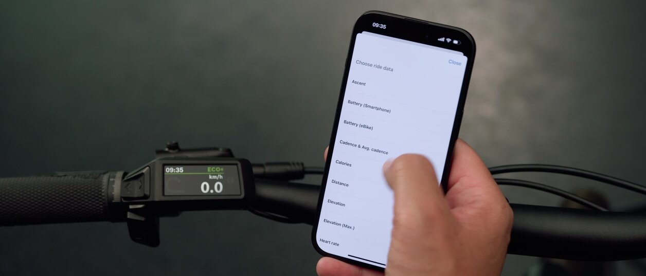 Shot of a smartphone adjusting settings for the Purion 200, which is visible in the background.