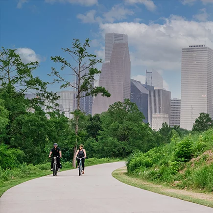 A man and a woman are seen enjoying a ride on Bosch-powered eBikes in a park near Houston, Texas.