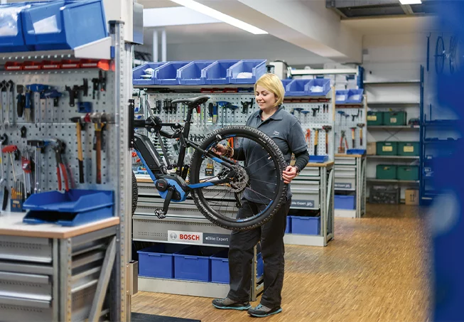 Female Mechanic checking tire