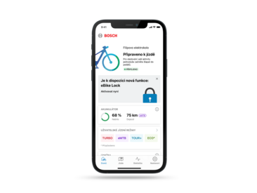 Telefon oříznutý na šedém pozadí. Na displeji je zobrazena domů v otevřené aplikaci eBike Flow.