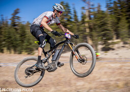 Helmeted rider jumping on a eMTB