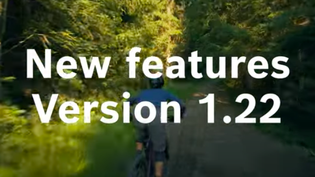 Video thumbnail with the text 'New Features Version 1.22' in white font, against the backdrop of a person swiftly riding an eBike through a forest.