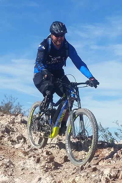 An eMountain bike rider navigates a stone path.