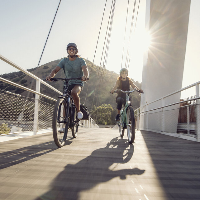 Two eBike riders crossing a bridge in Los Angeles.