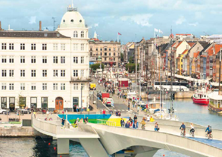 Padestrians and bike riders on a bridge in Amsterdam