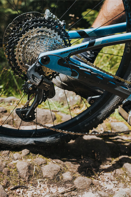 Close-up of the rear wheel of an eBike during an outdoor ride.