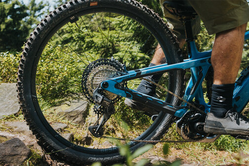 Close-up of the rear wheel of an eBike during an outdoor ride.