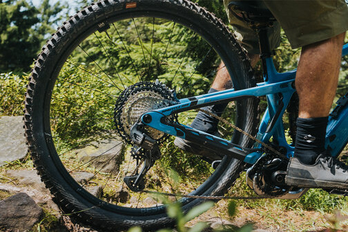 Close-up of the rear wheel of an eBike during an outdoor ride.