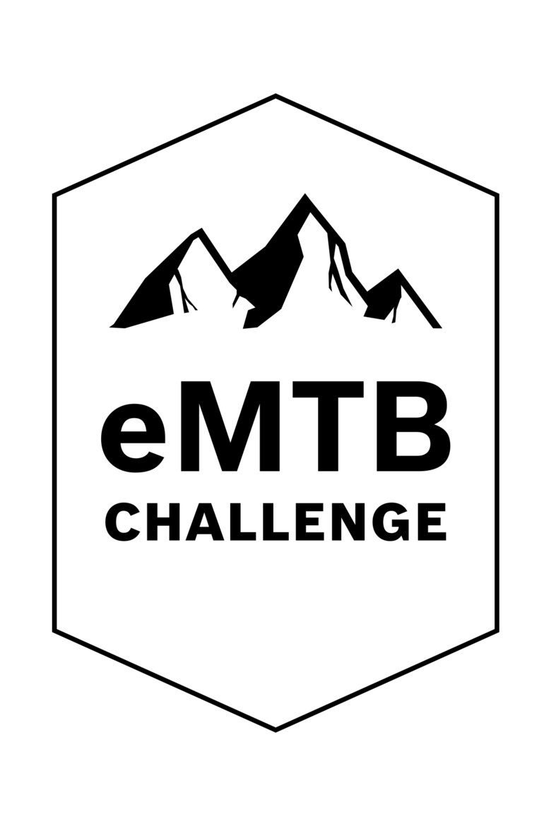 Logo de la eMTB Challenge : Un emblème hexagonal avec une silhouette de montagne stylisée et l’inscription « VTT AE CHALLENGE » sur un fond blanc.