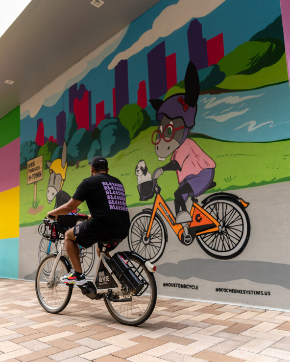 Houston Mural with Donkeeboy riding BCycle Bike Share eBike
