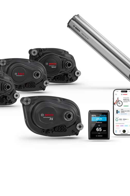 The drive units Cargo Line, Performance Line, Performance Line PX and Performance Line Speed, a Kiox, a smartphone with the eBike Flow app open, and the PowerTube 540 are displayed, along with a blue-purple speech bubble featuring "The smart system" on a white background.