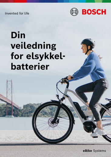 Omslag til en produktbrosjyre med teksten "Din elsykkelbatteri Guide". Bakgrunnsbildet viser en elsykkel-sjåfør. Nederst til høyre står "elsykkel Systems".