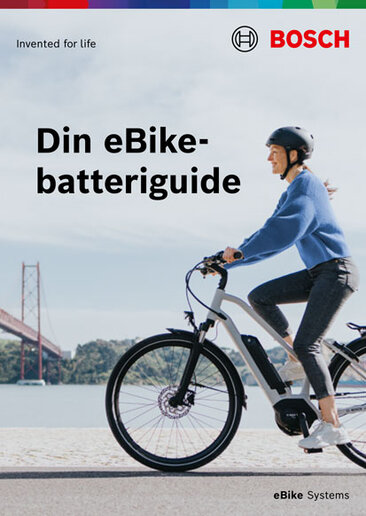 Omslag till en produktbroschyr med texten "Din eBike-batteri / elcykelbatteri Guide". Bakgrundsbilden visar en elcykel (/eBike)-förare. Längst ner till höger står det elcykel (/eBike) Systems.