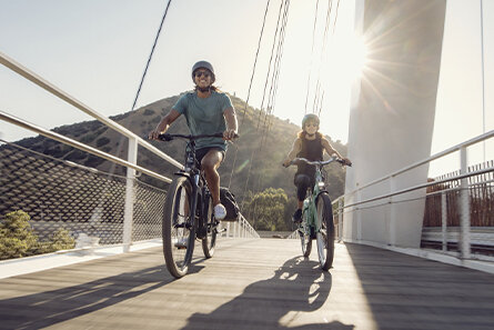 Two eBike riders going over a bridge in Los Angeles