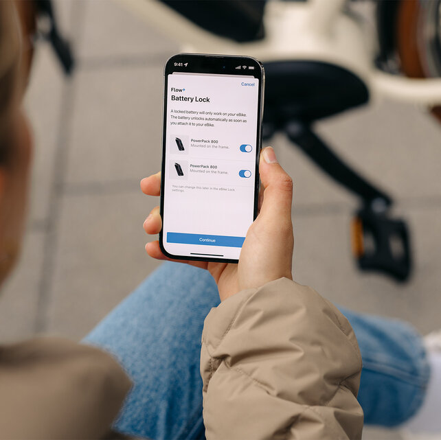 Focus on a smartphone where settings for Battery Lock are adjusted in the eBike Flow app.