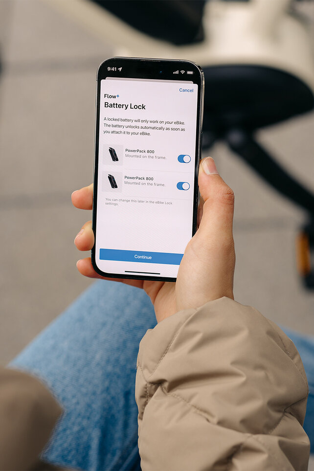 Focus on a smartphone where settings for Battery Lock are adjusted in the eBike Flow app.