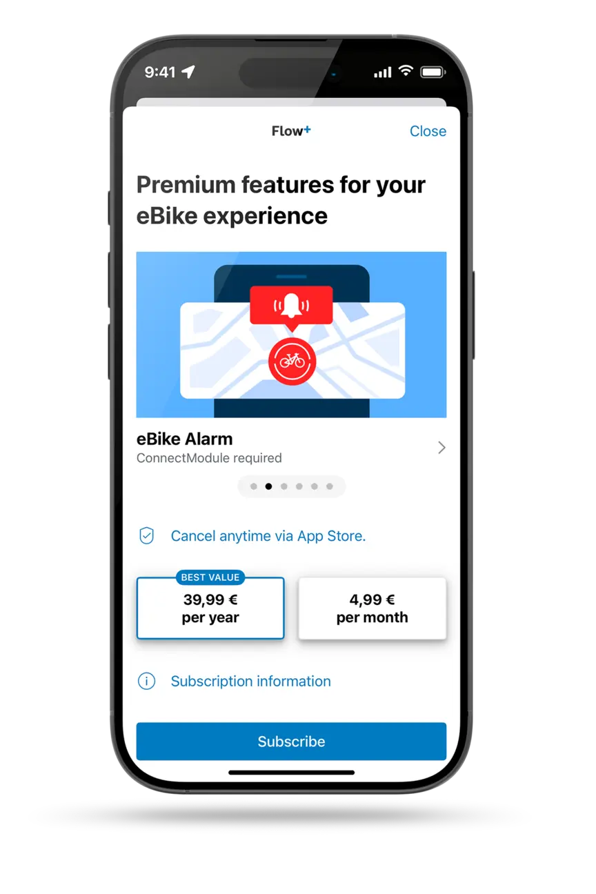 Freestanding smartphone displaying Flow+ subscription options. The premium feature eBike Alarm is also shown.