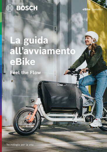 Copertina di una brochure di prodotto con il testo "Your eBike Starter Guide", sotto "Feel the Flow". L'immagine di sfondo mostra una eBiker. In alto a destra c'è "eBike Systems".
