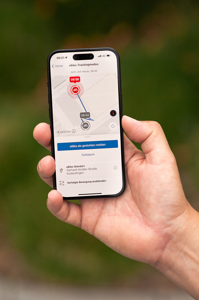Auf einem in der Hand gehaltenen Smartphone ist der eBike-Trackingmodus der Flow App von Bosch eBike Systems zu sehen.