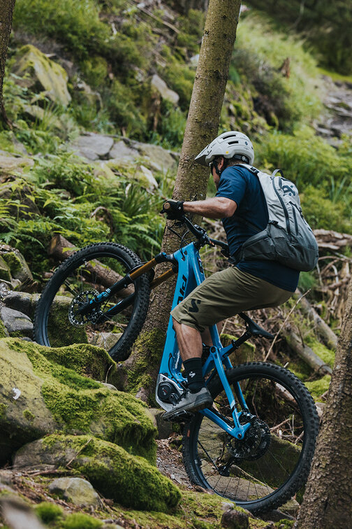 An eBiker rides over moss-covered stones in Sasbachwalden.