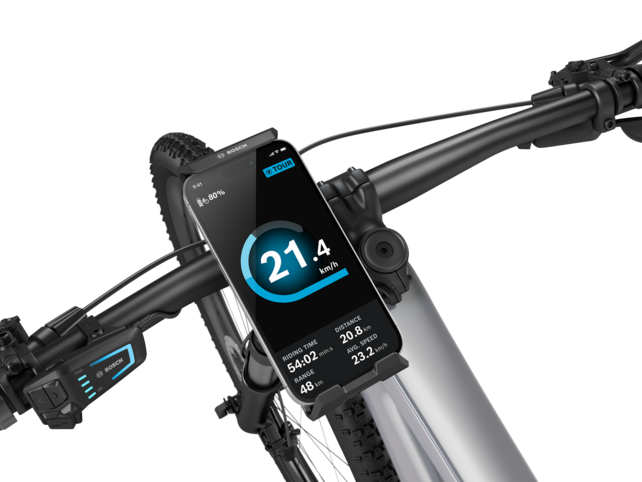 Close-up of the handlebars of an eBike, featuring a SmartphoneGrip Vertical with a smartphone inserted on the left side