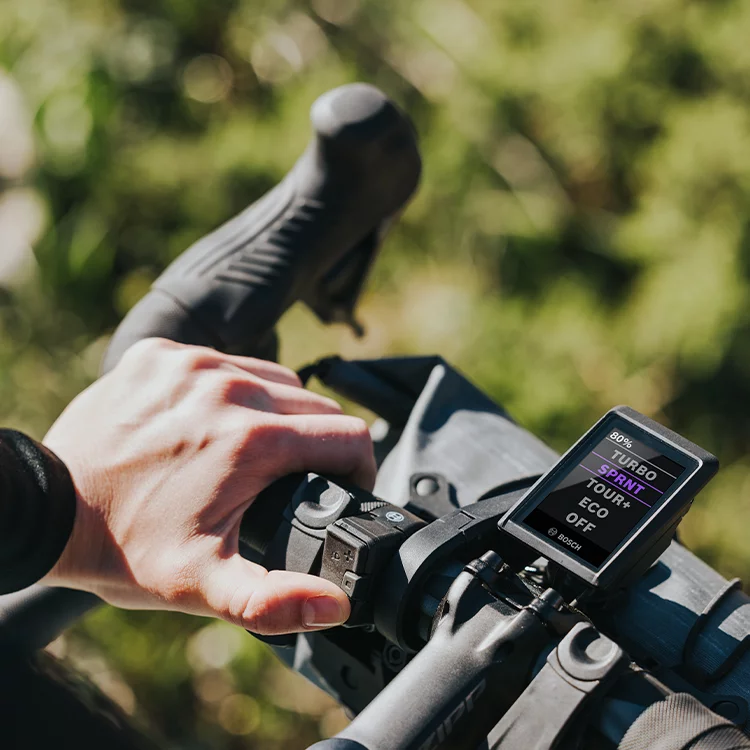 Close-up of a bicycle handlebar with Kiox display set in Sprint mode.